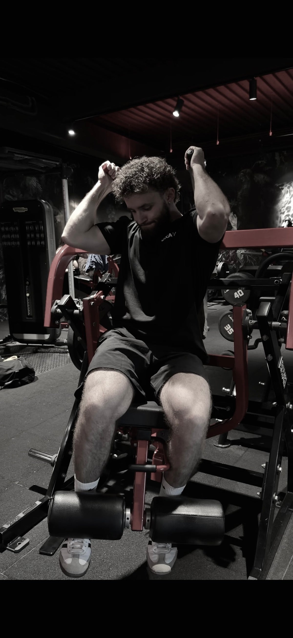 A football player sitting on the pitch, a GEL RESET bottle in front of him